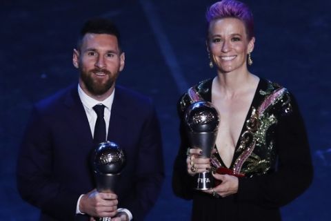 Argentinian Barcelona player Lionel Messi poses with United States forward Megan Rapinoe after they received the Best FIFA Men's, Women's player award during the Best FIFA soccer awards ceremony, in Milan's La Scala theater, northern Italy, Monday, Sept. 23, 2019. (AP Photo/Antonio Calanni)