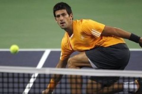 Serbia's Novak Djokovic watches the ball during a match against Rainer Schuettler of Germany at the Shanghai ATP Masters 1000 tennis tournament in Shanghai, China, Thursday, Oct. 15, 2009. Djokovic defeated Schuettler 6-4, 6-2. (AP Photo/Andy Wong)