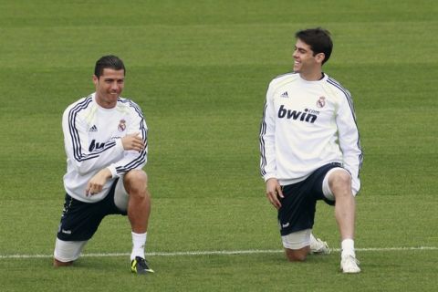 Real Madrid players Cristiano Ronaldo (L) and Kaka attend a training session at the Valdebebas training grounds outside Madrid April 19, 2011. Mourinho must resolve a tactical dilemma when he attempts to land his first piece of silverware as Real Madrid coach in Wednesday's King's Cup final against Barcelona at Valencia's Mestalla stadium. REUTERS/Andrea Comas (SPAIN - Tags: SPORT SOCCER)