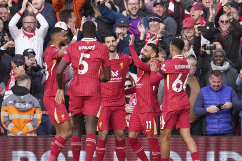 Liverpool's Mohamed Salah, centre right, celebrates with teammates after scoring his side's opening goal during the English Premier League soccer match between Liverpool and Chelsea at Anfield Stadium, Liverpool, England, Sunday, Oct. 20, 2024. (AP Photo/Jon Super)