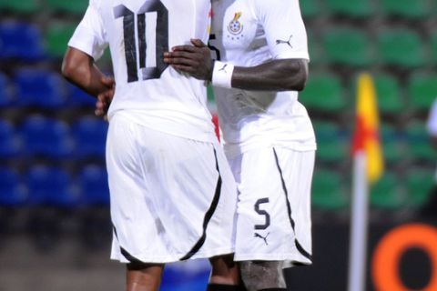 Ghana's forward Andre Ayew (L) commiserates team mate Jophn Mensah after being red carded during an African Cup of Nations (CAN) football match againt Botswanan at the Stade de Franceville on January 24, 2012. Ghana won 1-0.   AFP PHOTO / PIUS UTOMI EKPEI (Photo credit should read PIUS UTOMI EKPEI/AFP/Getty Images)