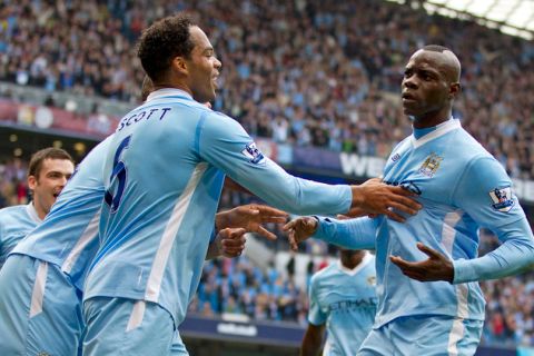 Manchester City's English defender Joleon Lescott (L) pushes away his team-mate Italian striker Mario Balotelli (R) after he scored the opening goal of the English Premier League football match between Manchester City and Aston Villa at Etihad Stadium in Manchester, north-west England on October 15, 2011. AFP PHOTO/ADRIAN DENNIS

RESTRICTED TO EDITORIAL USE. No use with unauthorized audio, video, data, fixture lists, club/league logos or live services. Online in-match use limited to 45 images, no video emulation. No use in betting, games or single club/league/player publications. (Photo credit should read ADRIAN DENNIS/AFP/Getty Images)