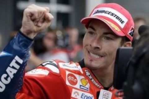 Nicky Hayden, of the United States, celebrates after finishing third in the Indianapolis Moto GP motorcycle race at Indianapolis Motor Speedway in Indianapolis, Sunday, Aug. 30, 2009. (AP Photo/Michael Conroy)