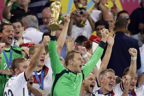 Germany's goalkeeper Manuel Neuer lifts the trophy amid his teammates after the World Cup final soccer match between Germany and Argentina at the Maracana Stadium in Rio de Janeiro, Brazil, Sunday, July 13, 2014. Germany beat Argentina 1-0 to win the World Cup. (AP Photo/Victor R. Caivano)