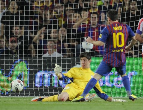 Barcelona's Argentinian forward Lionel Messi scores a goal during their Spanish League football match between FC Barcelona and Atletico de Madrid on September 24, 2011 at Camp Nou stadium in Barcelona. AFP PHOTO/LLUIS GENE (Photo credit should read LLUIS GENE/AFP/Getty Images)