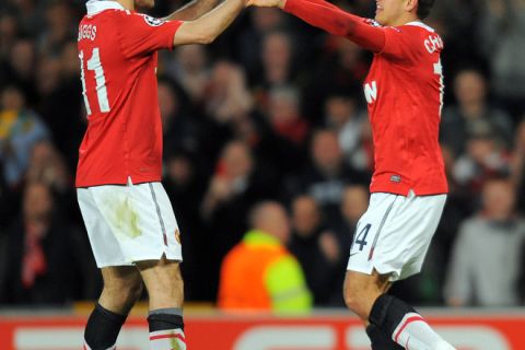 CORRECTING NAME OF THE PLAYER
Manchester United's Welsh midfielder Ryan Giggs (L) congratulates goal scorer Manchester United's Mexican forward Javier Hernandez during the UEFA Champions League quarter final second leg football match between Manchester United and Chelsea at Old Trafford in Manchester, north west England, on April 12, 2011. AFP PHOTO/ANDREW YATES (Photo credit should read ANDREW YATES/AFP/Getty Images)