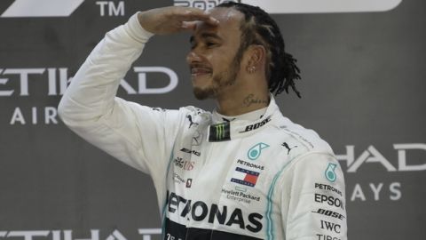 Mercedes driver Lewis Hamilton of Britain celebrates on the podium after wining the Emirates Formula One Grand Prix, at the Yas Marina racetrack in Abu Dhabi, United Arab Emirates, Sunday, Dec.1, 2019. (AP Photo/Luca Bruno)