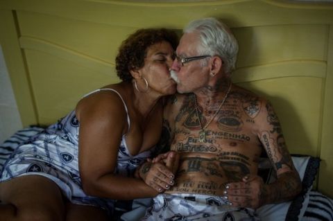 TO GO WITH AFP STORY by Javier Tovar
Brazilian football club Botafogo fan Delneri Martins Viana, a 69-year-old retired soldier, relaxes with his wife Vina at their home in Rio de Janeiro, Brazil, on January 18, 2014. Delneri has 83 tattoos on his body dedicated to Botafogo and describes himself as the club's biggest fan.   AFP PHOTO / YASUYOSHI CHIBA