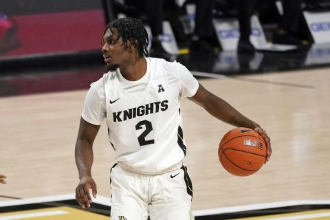 Central Florida guard Darius Perry (2) looks to pass the ball during the first half of an NCAA college basketball game against Houston, Saturday, Dec. 26, 2020, in Orlando, Fla. (AP Photo/John Raoux)