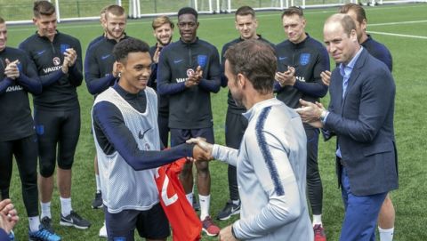 Britain's Prince William, right, meets members of the England soccer team, during his visit to the FA training ground ahead of their friendly match against Costa Rica, in Leeds, England, Thursday, June 7, 2018. (Charlotte Graham/Pool Photo via AP)