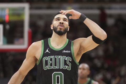 Boston Celtics' Jayson Tatum blows a kiss skyward after scoring a 3-point basket during the second half of an NBA basketball game against the Chicago Bulls on Saturday, Dec. 21, 2024, in Chicago. (AP Photo/Charles Rex Arbogast)