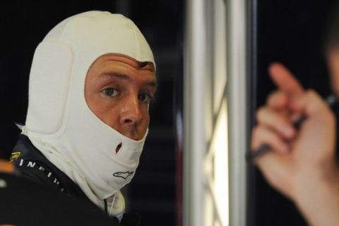 Red Bull Racing's German driver Sebastian Vettel stands in the pits at the Autodromo Nazionale circuit on September 10, 2011 in Monza during the third practice session of the Formula One Italian Grand Prix. AFP PHOTO / DIMITAR DILKOFF (Photo credit should read DIMITAR DILKOFF/AFP/Getty Images)