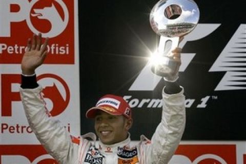 Sun reflects in the trophy of second placed McLaren Mercedes Formula One driver Lewis Hamilton of Britain during the victory ceremony of the the Turkish Grand Prix at the Istanbul Park Formula One circuit in Istanbul, Turkey, Sunday, May 11, 2008. (AP Photo/Murad Sezer)