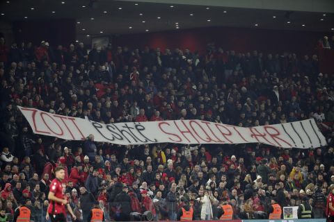 Fans of the national team hold a banner that reads "God is Albanian" during the Euro 2024 group E qualifying soccer match between Albania and Faroe Islands at Air Albania stadium in Tirana, Albania, Monday, Nov. 20, 2023. (AP Photo/Armando Babani)