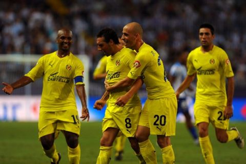 Villarreal's midfielder Santi Cazorla (2L) celebrates wtih midfielder Borja Valero (2R) after scoring against Malaga C.F. during a Spanish league football match at Rosaleda stadium on September 27, 2010. AFP PHOTO / JORGE GUERRERO (Photo credit should read Jorge Guerrero/AFP/Getty Images)