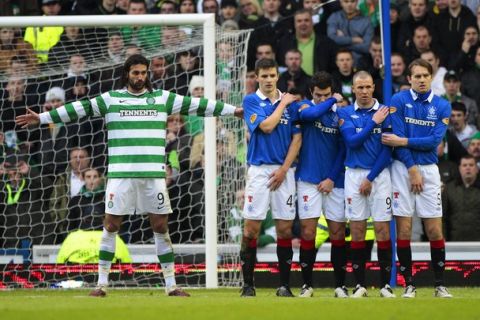 Celtic's Georgios Samaras (L) gestures as he stands next to Rangers' players during their Scottish Premier League 'Old Firm' soccer match at Ibrox stadium in Glasgow, Scotland January 2, 2011. REUTERS/David Moir (BRITAIN - Tags: SPORT SOCCER)