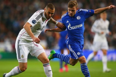 MADRID, SPAIN - MARCH 10:  Karim Benzema of Real Madrid CF holds off Max Meyer of Schalke during the UEFA Champions League Round of 16 second leg match between Real Madrid CF and FC Schalke 04  at Estadio Bernabeu on March 10, 2015 in Madrid, Spain.  (Photo by Alex Grimm/Bongarts/Getty Images)