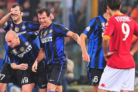 Inter Milan's Serbian midfielder Dejan Stankovic (C) celebrates after scoring with teamates Inter Milan's Dutch midfielder Wesley Sneijder (C bottom) and Inter Milan's Macedonian forward Goran Pandev (L) during Italian Tim Cup first leg semi-finals football match As Roma vs InterMilan , at Olympic stadium in Rome on April 19, 2011.  AFP PHOTO / ALBERTO PIZZOLI
