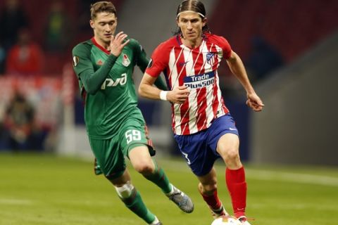 Atletico Madrid's Filipe Luis, right, is challenged by Lokomotiv's Aleksei Miranchuk during the Europa League Round of 16 first leg soccer match between Atletico Madrid and Lokomotiv Moscow at the Metropolitano stadium in Madrid, Thursday, March 8, 2018. (AP Photo/Francisco Seco)