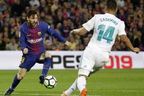 Barcelona's Lionel Messi scores his side's second goal during a Spanish La Liga soccer match between Barcelona and Real Madrid, dubbed 'El Clasico', at the Camp Nou stadium in Barcelona, Spain, Sunday, May 6, 2018. (AP Photo/Emilio Morenatti)