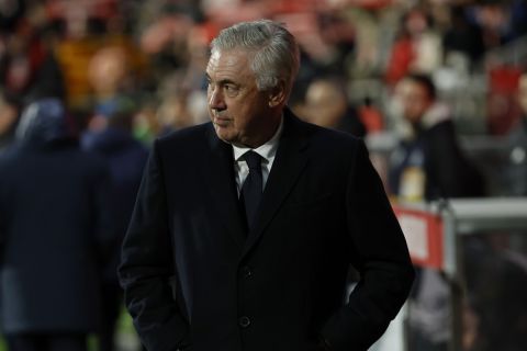 Real Madrid's head coach Carlo Ancelotti walks to the bench before a Spanish La Liga soccer match between Girona and Real Madrid at the Montilivi stadium in Girona, Spain, Saturday, Dec. 7, 2024. (AP Photo/Joan Monfort)