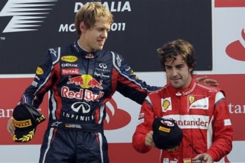 Red Bull driver Sebastian Vettel of Germany, left, congratulates third place Ferrari driver Fernando Alonso of Spain after winning the Italian Formula One Grand Prix at the Monza racetrack, in Monza, Italy, Sunday, Sept.11, 2011. (AP Photo/Luca Bruno)