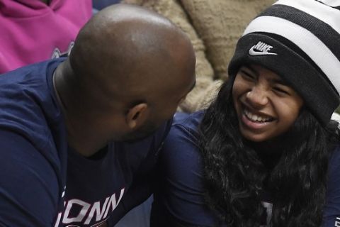 Kobe Bryant and his daughter Gianna watch the first half of an NCAA college basketball game between Connecticut and Houston, Saturday, March 2, 2019, in Storrs, Conn. (AP Photo/Jessica Hill)