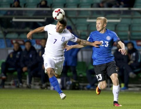 Greece's Nikolaos Karelis, left, and Estonia's Taijo Teniste struggle for a ball during their World Cup Group H qualifying soccer match between Estonia and Greece in Tallinn, Estonia, on Tuesday, March 29, 2016. (AP Photo/Liis Treimann)