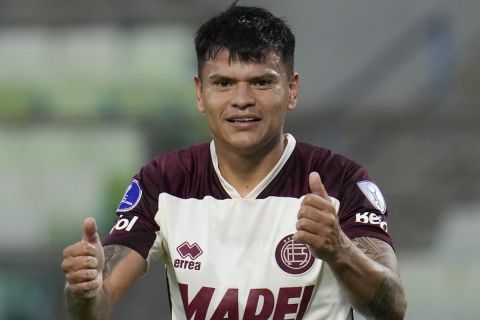 Walter Bou of Argentina's Lanus celebrates scoring his side's second goal against Venezuela's Metropolitanos during a Copa Sudamericana group G soccer match at University of Caracas Olympic stadium in Caracas, Venezuela, Thursday, April 25, 2024. (AP Photo/Ariana Cubillos)