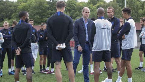 Britain's Prince William, centre right, talks to members of the England soccer team, during his visit to the FA training ground to meet players ahead of their friendly match against Costa Rica, in Leeds, England, Thursday, June 7, 2018. (Charlotte Graham/Pool Photo via AP)