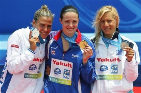 Medalists from the the women's 10km Open Water swimming event from left, Italy's Martina Grimaldi silver, Britain's Keri Ann Michelle Payne gold and Greece's Marianna Lymperta bronze, pose on the podium at the FINA Swimming World Championships at Jinshan Beach in Shanghai, China, Tuesday, July 19, 2011. (AP Photo/Eugene Hoshiko)