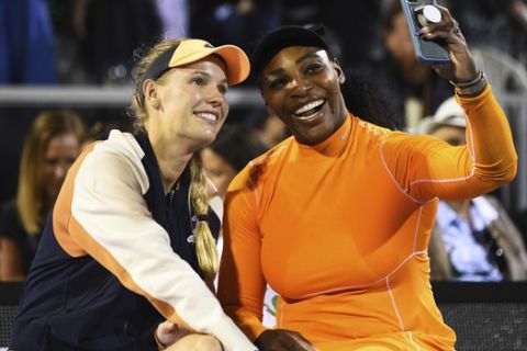 Denmark's Caroline Wozniacki and United States Serena Williams share a selfie after their finals doubles match against United States player Asia Muhammad and Taylor Townsend from the United States at the ASB Classic in Auckland, New Zealand, Sunday, Jan 12, 2020. (Chris Symes/Photosport via AP)