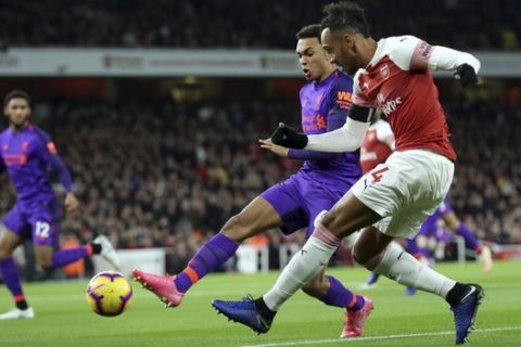 Liverpool's Trent Alexander-Arnold tries to block a shot from Arsenal's Pierre-Emerick Aubameyang, right, during the English Premier League soccer match between Arsenal and Liverpool at Emirates stadium in London, England, Saturday, Nov. 3, 2018. (AP Photo/Tim Ireland)