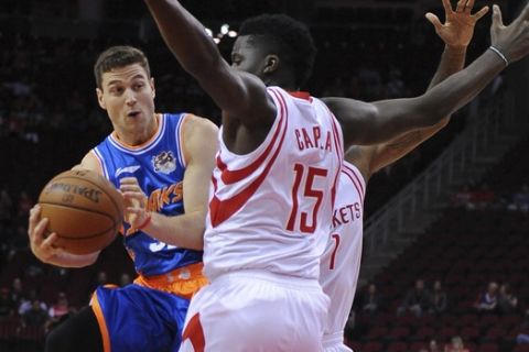 The Shanghai Sharks Jimmer Fredette, left, drives by the Houston Rockets Clint Cappella, right,  in the first half of an NBA basketball exhibition game Sunday, Oct. 2, 2016, in Houston. (AP Photo/George Bridges)