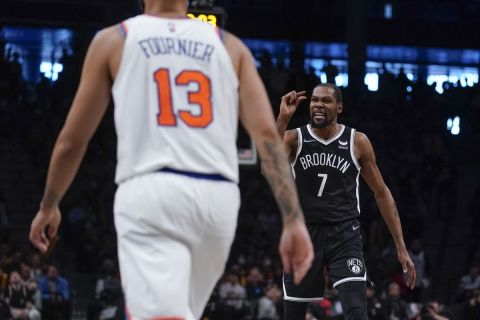 Brooklyn Nets' Kevin Durant, right, reacts after hitting a basket during the second half of the NBA basketball game against the New York Knicks at the Barclays Center, Sunday, Mar. 13, 2022, in New York. The Nets defeated the Knicks 110-107. (AP Photo/Seth Wenig)