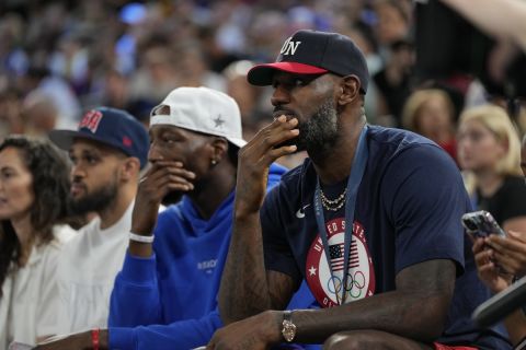 LeBron James watches during a women's gold medal basketball game at Bercy Arena at the 2024 Summer Olympics, Sunday, Aug. 11, 2024, in Paris, France. (AP Photo/Michael Conroy)