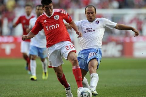 Benficas Argentinian forward Nicolas Gaitan (L) vies for the ball with Trazbonsport's midfielder Serkan Balci during their Champions League qualifying football match at the Luz Stadium in Lisbon, on July 27, 2011. AFP PHOTO/ FRANCISCO LEONG (Photo credit should read FRANCISCO LEONG/AFP/Getty Images)