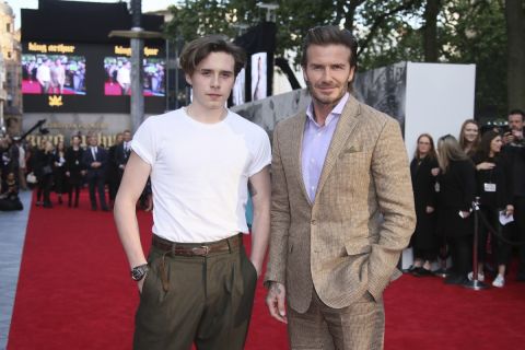 Actor David Beckham, right, poses with his son Brooklyn Beckham for photographers upon arrival at the premiere of the film 'King Arthur The Legend Of The Sword'', in London, Wednesday, May 10, 2017. (Photo by Joel Ryan/Invision/AP)