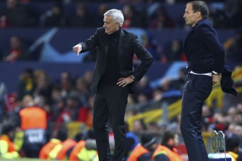 ManU coach Jose Mourinho gestures next to Juventus coach Massimiliano Allegri, right, during the Champions League group H soccer match between Manchester United and Juventus at Old Trafford, Manchester, England, Tuesday, Oct. 23, 2018. (AP Photo/Dave Thompson)