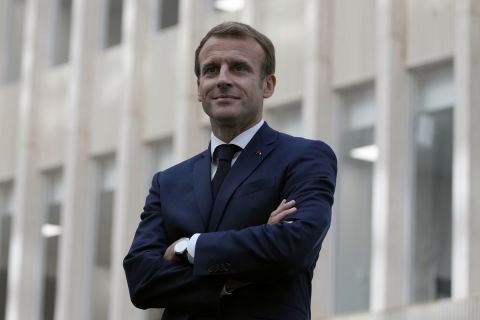 French President Emmanuel Macron arrives with Head of Paris 2024 Tony Estanguet to talk to staff members at the headquarters of the Paris 2024 Organizing Committee, in Saint Denis, outside Paris, Thursday, Oct.14, 2021. French President Emmanuel Macron said Thursday that the government will help fund 5,000 local facilities to allow more people to practice sports, especially in the country's poorest areas, ahead of the Paris 2024 Olympics. (AP Photo/Francois Mori, Pool)