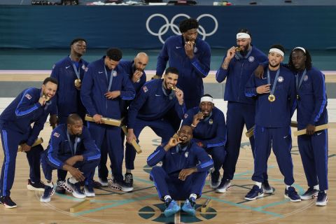 The United States team celebrates after winning a men's gold medal basketball game against France at Bercy Arena at the 2024 Summer Olympics, Saturday, Aug. 10, 2024, in Paris, France. (AP Photo/Michael Conroy)