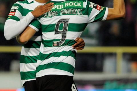 Sporting CP's Dutch forward Ricky van Wolfswinkel (R) celebrates with a teammate after scoring a goal during the Portuguese super league football match between Feirense and Sporting CP, at the Municipal Stadium, in Aveiro, on October 30, 2011. AFP PHOTO / MIGUEL RIOPA (Photo credit should read MIGUEL RIOPA/AFP/Getty Images)