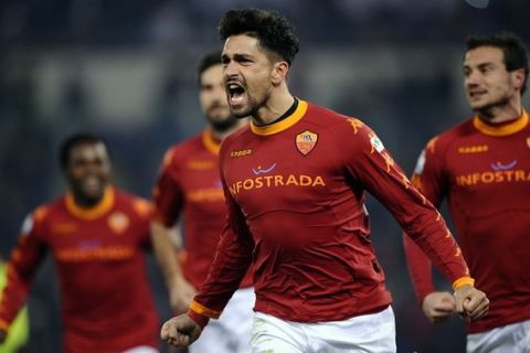 AS Roma's forwards Marco Borriello (C) celebrates after scoring against Lazio during their Italian Cup football match in Rome's Olympic Stadium on January 19,2011.  AFP PHOTO / Filippo MONTEFORTE (Photo credit should read FILIPPO MONTEFORTE/AFP/Getty Images)