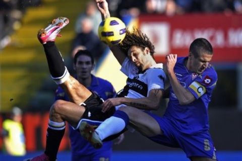 Parma's Carvalho Amauri of Brazil, left, scores past Fiorentina defender Alessandro Gamberini, during their Serie A soccer match at Parma's Tardini stadium, Italy, Sunday, Feb. 6, 2011. (AP Photo/Marco Vasini)