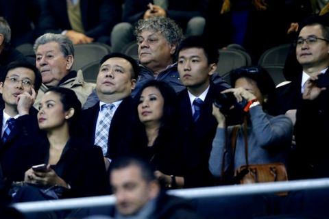 In this photo taken on Nov. 6, 2016, from left: Inter Milan CEO Liu Jun, Inter Milan Board of Directors members Ren Jun, Zhang Steven and Yang Yang attend a Serie A soccer match between Inter Milan and Crotone at the San Siro stadium in Milan, Italy. Next Sunday's will likely be Silvio Berlusconi's final derby as AC Milan owner. And the first for Inter's new Chinese proprietors.(AP Photo/Antonio Calanni)