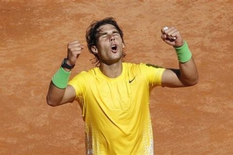 Spain's Rafael Nadal celebrates after winning his semifinal match against France's Richard Gasquet, at the Italian Open tennis tournament, in Rome, Saturday, May 14, 2011. Rafael Nadal overcame a stiff first-set challenge from Richard Gasquet before rolling to a 7-5, 6-1 win Saturday in the Italian Open semifinals. The top-ranked Spaniard faced break points in three different games during the first set but won all of them to improve his career record against Gasquet to 9-0. (AP Photo/Riccardo De Luca)