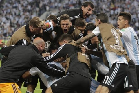 Argentina players celebrates his side's second goal by Argentina's Marcos Rojo during the group D match between Argentina and Nigeria at the 2018 soccer World Cup in the St. Petersburg Stadium in St. Petersburg, Russia, Tuesday, June 26, 2018. (AP Photo/Dmitri Lovetsky)