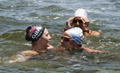 Britain's Keri Ann Michelle Payne left, is congratulated by Martina Grimaldi of Italy, forward right, and Marianna Lymperta of Greece, rear, after she won the women's 10km Open Water swimming event at the FINA Swimming World Championships at Jinshan Beach in Shanghai, China, Tuesday, July 19, 2011. Payne won the competition. (AP Photo/Eugene Hoshiko)