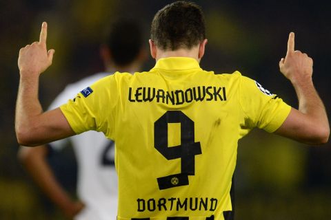 Dortmund's Polish striker Robert Lewandowski celebrates scoring during the UEFA Champions League semi final first leg football match Borussia Dortmund vs Real Madrid on April 24, 2013 in Dortmund, western Germany. AFP PHOTO / PATRIK STOLLARZ        (Photo credit should read PATRIK STOLLARZ/AFP/Getty Images)