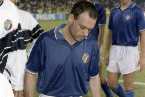 Italy's top scorer Salvatore Schillaci leaves the field at the end of the soccer World Cup semi-final of Italy against Argentina, on July 3, 1990 in Naples, Italy. Argentina won by penalty kicks and advanced to the final. (AP Photo/Karl Heinz Kreifelts)